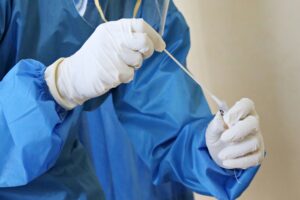 Tech using a swab specimen to test for STDs. 