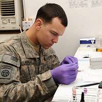 U.S. Soldier performing a laboratory test in Iraq. - Original Photo