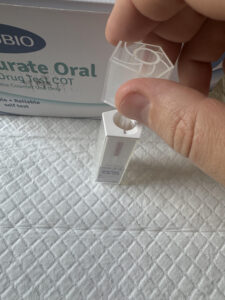 Securing swab into the test device