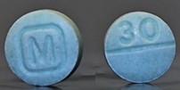 Counterfeit M30 pills laced with Fentanyl. These pills are illegally made by using a "pill press". -Photo courtesy of DEA